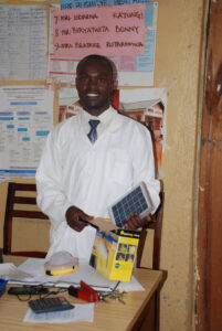 Bless receives a solar lantern donated by Solar Light for Africa.